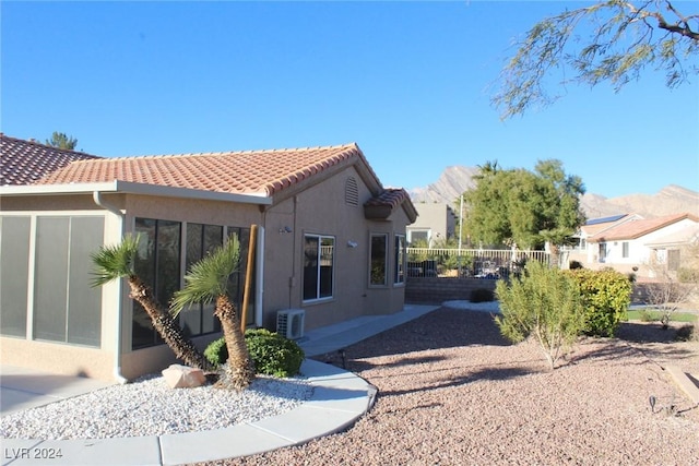 view of property exterior with a mountain view