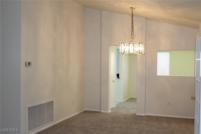 empty room featuring carpet flooring and lofted ceiling