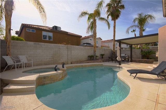 view of swimming pool featuring an in ground hot tub and a patio