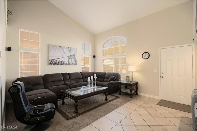 living room with light tile patterned floors and high vaulted ceiling