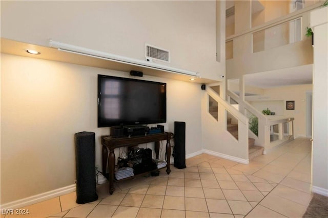 tiled living room featuring a high ceiling