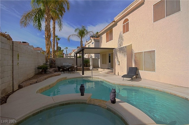 view of swimming pool with a patio area and an in ground hot tub