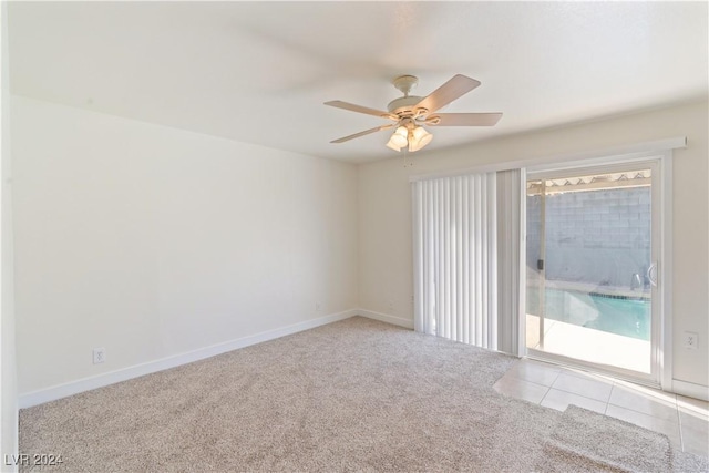 unfurnished room featuring ceiling fan and light carpet