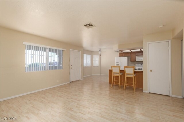 304 S Buffalo Dr Unit 201, Las Vegas, NV 89145 - unfurnished living room featuring light hardwood / wood-style floors