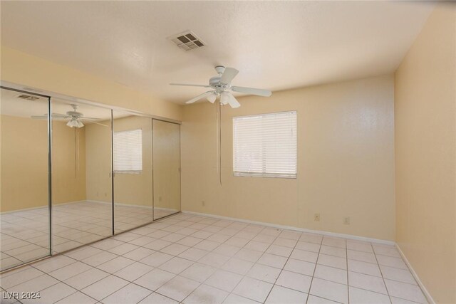304 S Buffalo Dr Unit 201, Las Vegas, NV 89145 - unfurnished bedroom featuring ceiling fan, light tile patterned flooring, and a closet