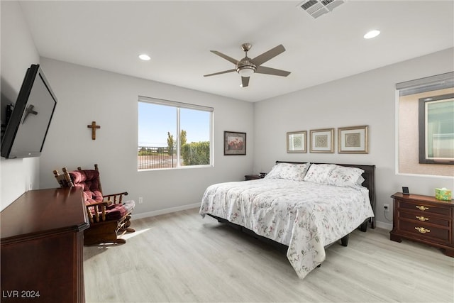 bedroom with ceiling fan and light hardwood / wood-style floors