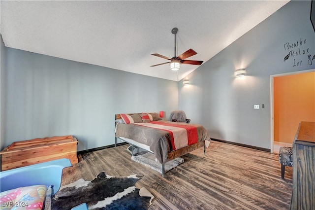 bedroom with hardwood / wood-style floors, a textured ceiling, high vaulted ceiling, and ceiling fan