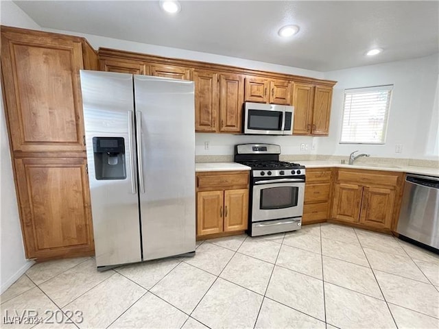 kitchen featuring light tile patterned floors, sink, and appliances with stainless steel finishes