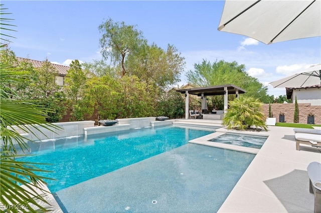 view of swimming pool featuring an in ground hot tub and a patio