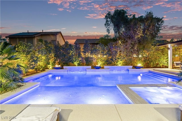 view of pool at dusk