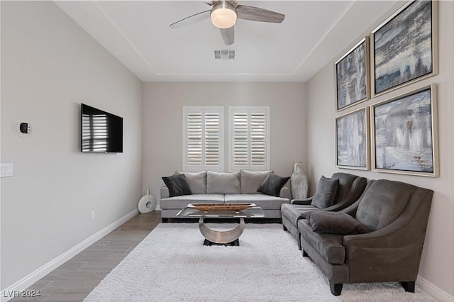 living room featuring hardwood / wood-style flooring and ceiling fan