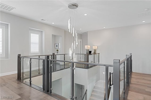 stairs with hardwood / wood-style floors