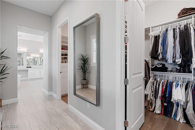 spacious closet featuring light hardwood / wood-style floors