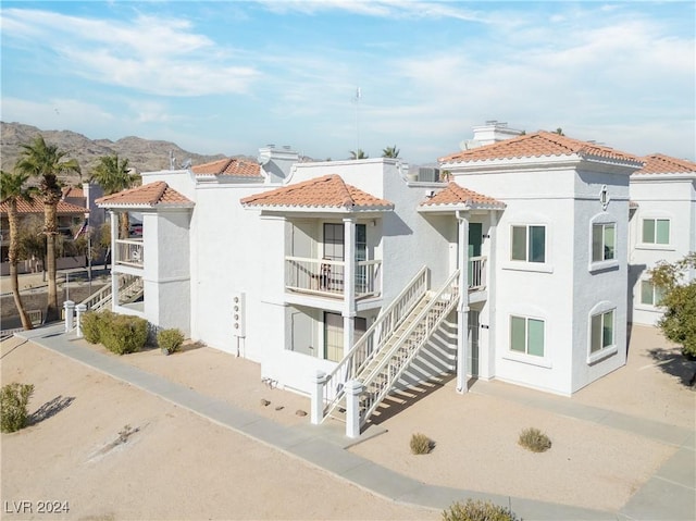 view of property with a mountain view and central air condition unit