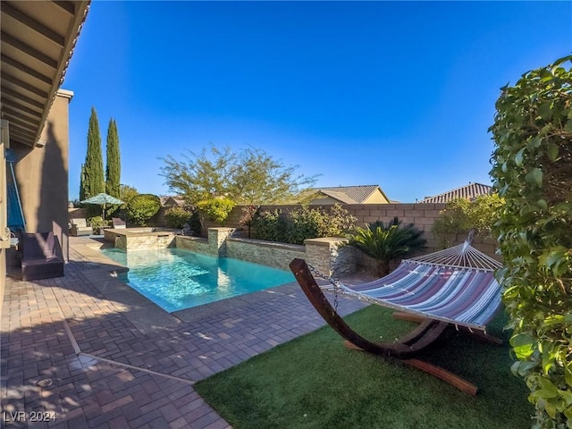 view of pool featuring a hot tub and a patio area