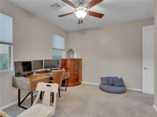 office space with light colored carpet and ceiling fan