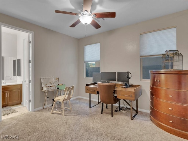 carpeted office space with ceiling fan