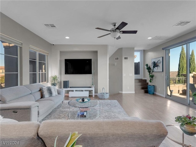 living room featuring ceiling fan and hardwood / wood-style floors