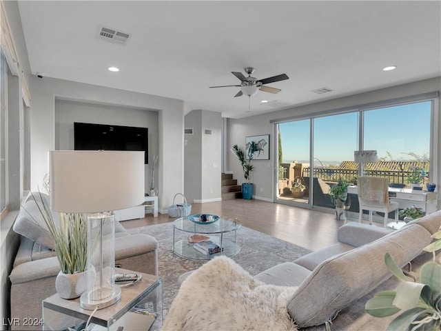 living room with ceiling fan and wood-type flooring