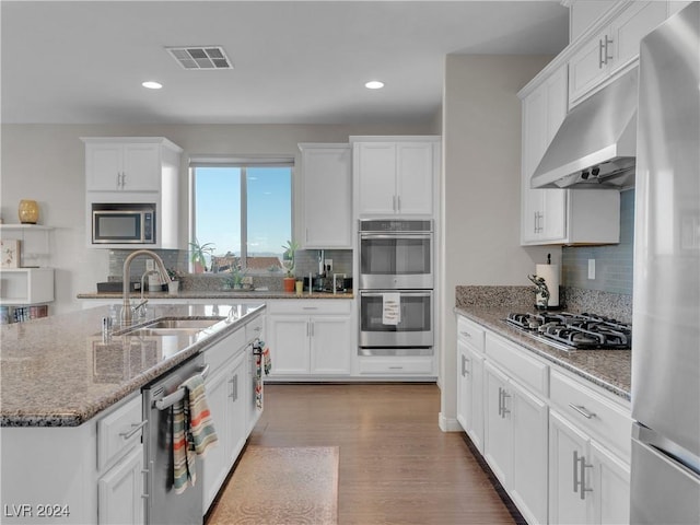 kitchen with decorative backsplash, sink, and appliances with stainless steel finishes