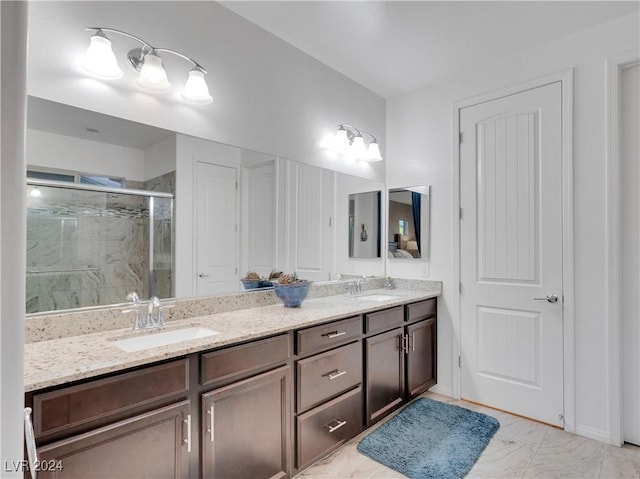 bathroom with vanity and a shower with door