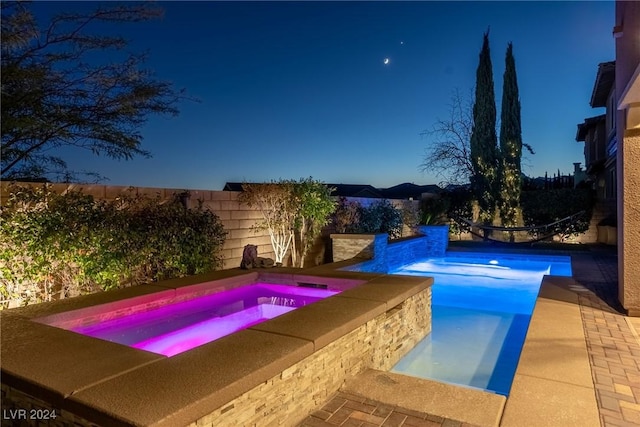 view of pool featuring an in ground hot tub