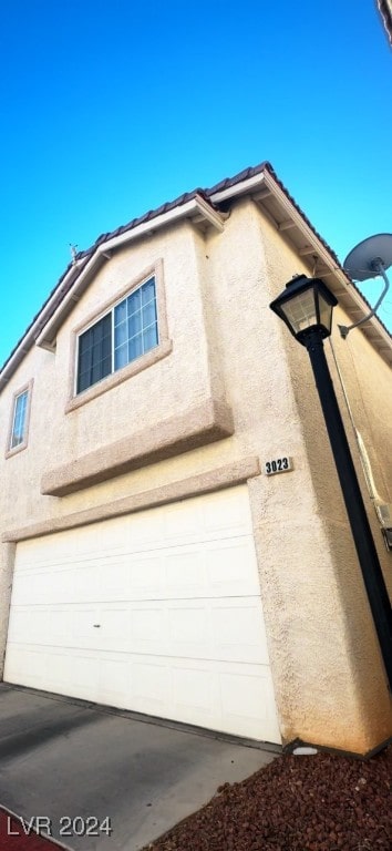 view of side of property with a garage