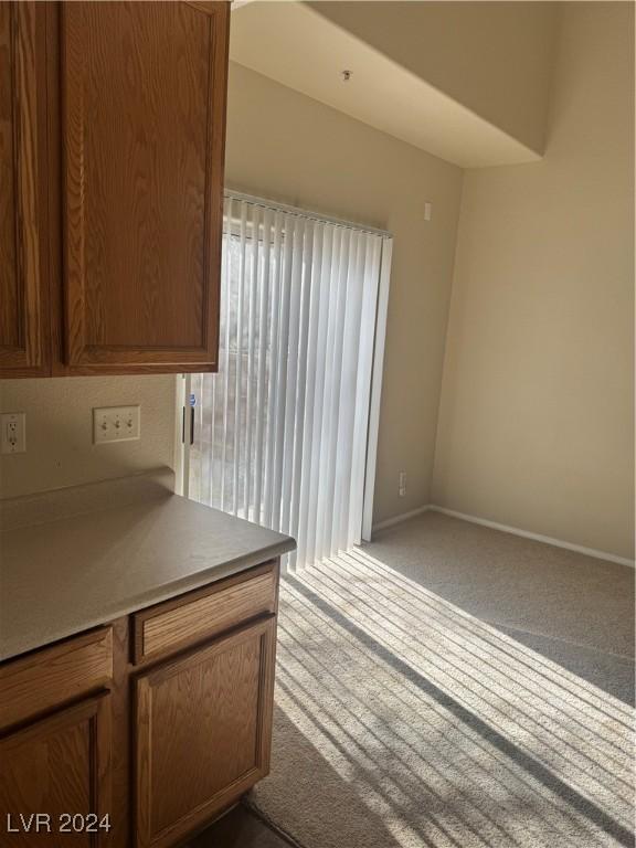 kitchen with light colored carpet