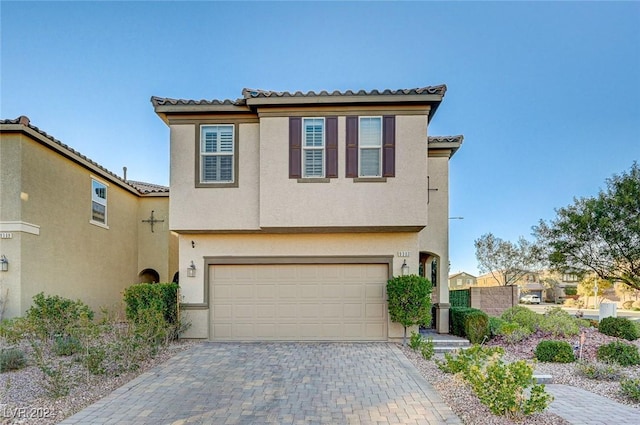 9303 Ettrick Ct, Las Vegas, NV 89178 - view of front facade with a tile roof, stucco siding, and a garage