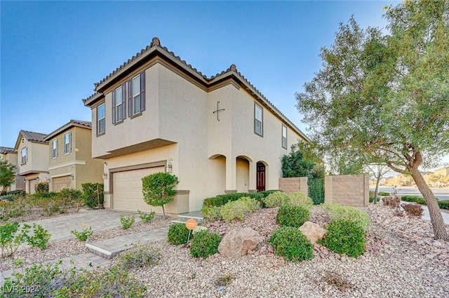 9303 Ettrick Ct, Las Vegas, NV 89178 - view of front of house with stucco siding, an attached garage, a tile roof, and driveway