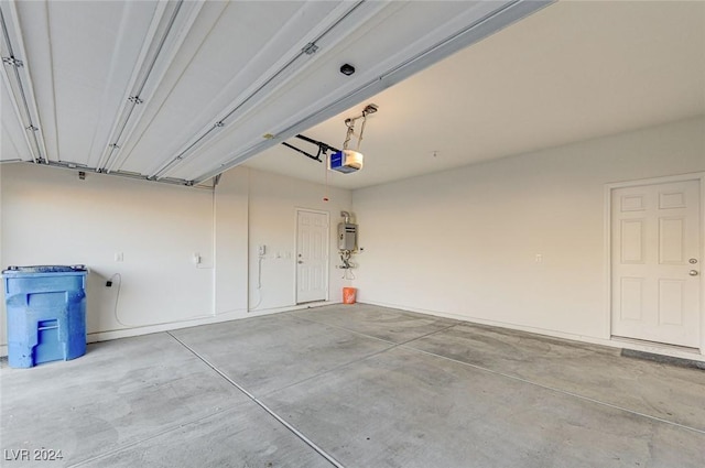 garage featuring strapped water heater and a garage door opener