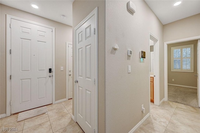 hall featuring light tile patterned flooring