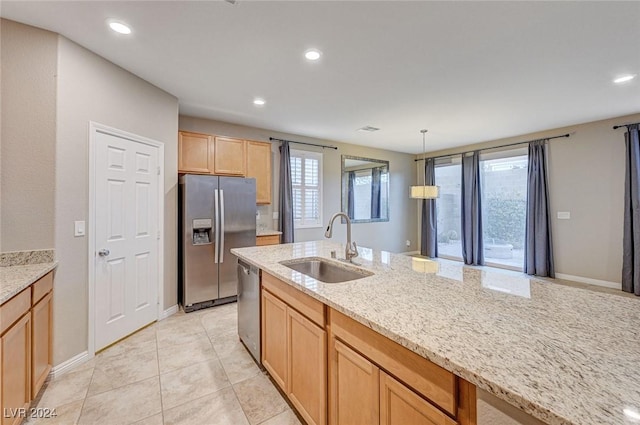9303 Ettrick Ct, Las Vegas, NV 89178 - kitchen with appliances with stainless steel finishes, a sink, light stone counters, light brown cabinetry, and decorative light fixtures