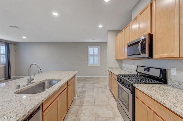 9303 Ettrick Ct, Las Vegas, NV 89178 - kitchen with appliances with stainless steel finishes, a sink, light brown cabinets, light stone countertops, and recessed lighting