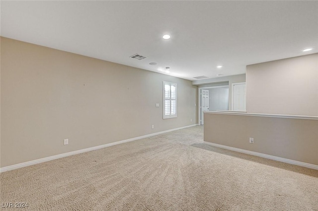 unfurnished room featuring light carpet