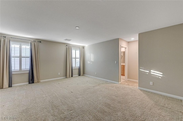 carpeted spare room with a wealth of natural light