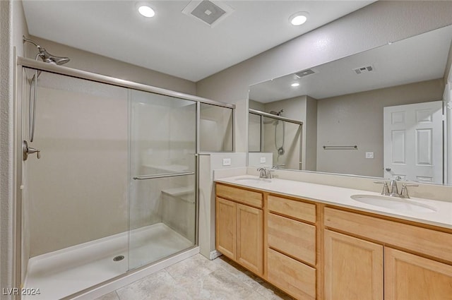 bathroom with tile patterned flooring, vanity, and a shower with shower door