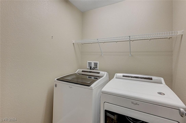 washroom with washing machine and clothes dryer