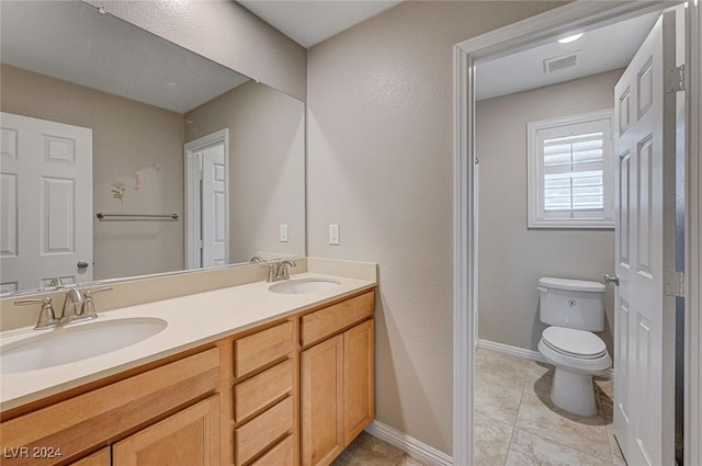 bathroom featuring tile patterned floors, vanity, and toilet