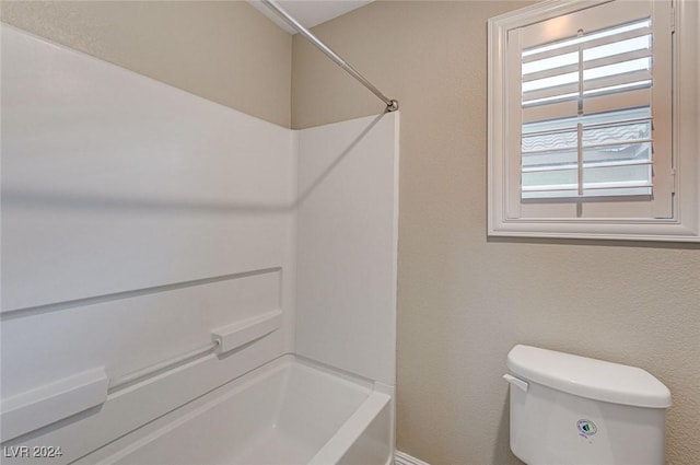 bathroom featuring toilet and bathing tub / shower combination