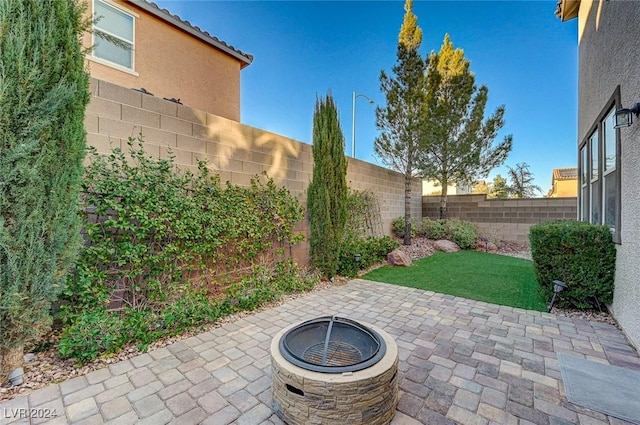 9303 Ettrick Ct, Las Vegas, NV 89178 - fenced backyard featuring a patio area and an outdoor fire pit