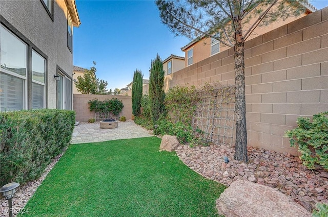 view of yard with an outdoor fire pit and a patio