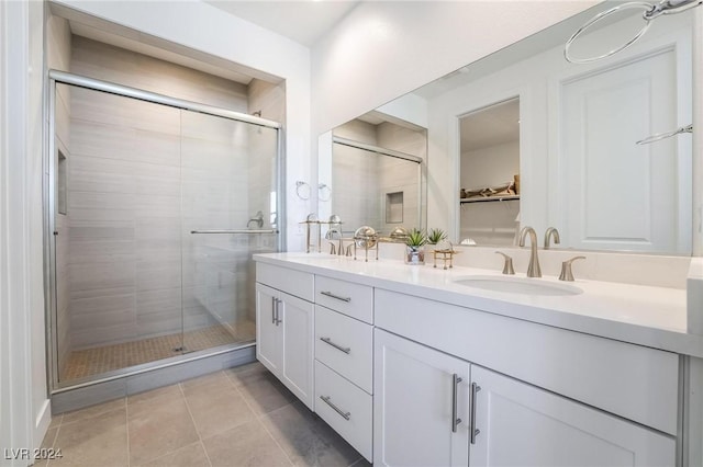 bathroom featuring vanity, tile patterned floors, and walk in shower