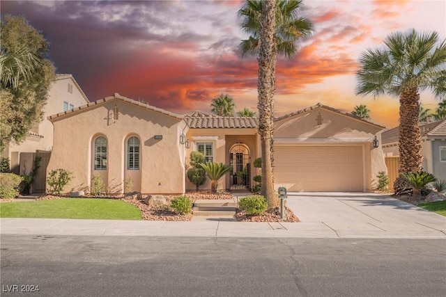 mediterranean / spanish-style home featuring a garage