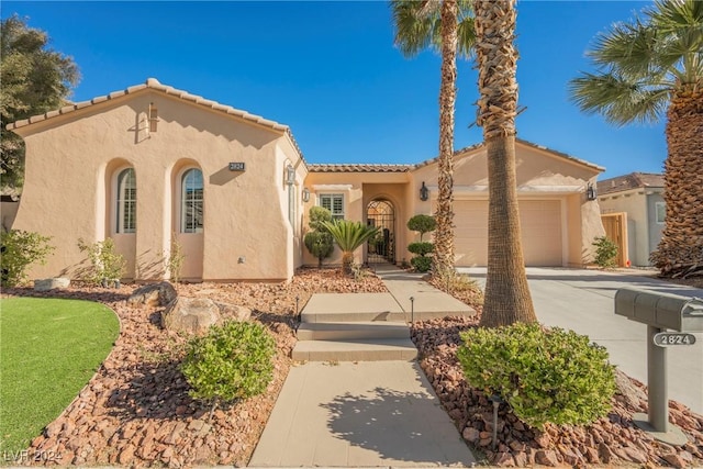 mediterranean / spanish-style house with a garage