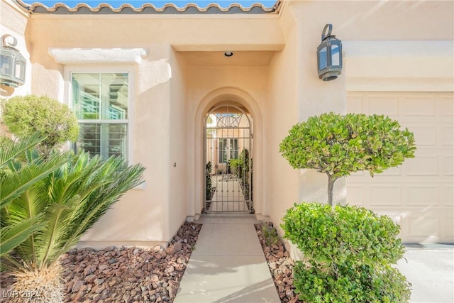 doorway to property with a garage