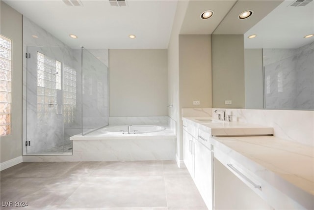 bathroom with tile patterned flooring, vanity, and separate shower and tub