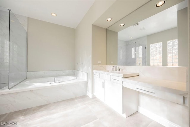 bathroom featuring tile patterned flooring, vanity, and plus walk in shower