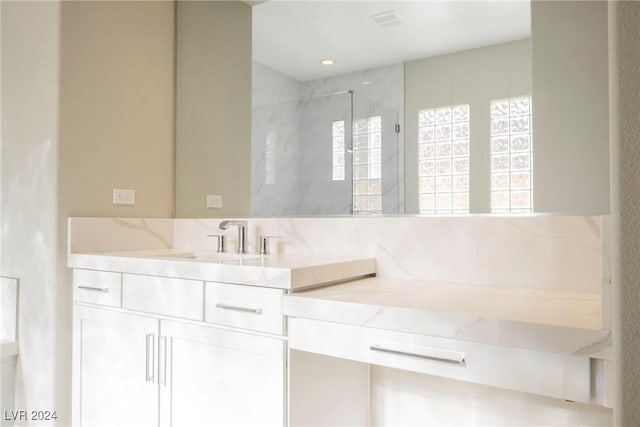 bathroom featuring vanity and walk in shower