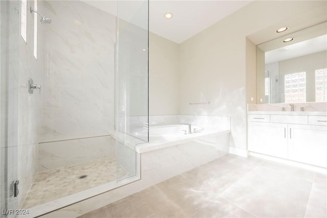 bathroom with tile patterned flooring, vanity, and separate shower and tub